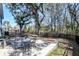 Landscaped backyard with patio seating, mature trees, and lush greenery at 2317 Chisol Plow St, Mount Pleasant, SC 29466