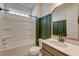 Well-lit bathroom with a shower-tub, modern fixtures, and wainscotting at 2317 Chisol Plow St, Mount Pleasant, SC 29466