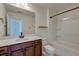 Bathroom with a dark wood vanity, stone countertop, and a shower-tub combination at 2317 Chisol Plow St, Mount Pleasant, SC 29466
