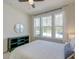 Bright bedroom featuring a large window, stylish decor, and a comfortable bed at 2317 Chisol Plow St, Mount Pleasant, SC 29466