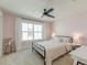 Bedroom with pink walls, carpet, and ample light from the large window at 2317 Chisol Plow St, Mount Pleasant, SC 29466