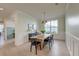 Elegant dining room featuring a long table, modern lighting, and bright, neutral wall colors at 2317 Chisol Plow St, Mount Pleasant, SC 29466