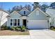 Charming, light-blue single-Gathering home boasts beautiful curb appeal with a well-manicured lawn and two-car garage at 2317 Chisol Plow St, Mount Pleasant, SC 29466