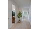 Bright hallway with light wood flooring, modern trim, and a glimpse into a clean, well-lit bathroom at 2317 Chisol Plow St, Mount Pleasant, SC 29466