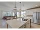 Bright, open kitchen featuring a large island, modern pendant lighting, and stainless steel appliances at 2317 Chisol Plow St, Mount Pleasant, SC 29466