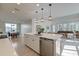 Modern kitchen island features white countertops, stainless steel appliances, and seamless flow to dining and living areas at 2317 Chisol Plow St, Mount Pleasant, SC 29466