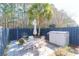 Serene backyard featuring patio seating, palm trees, and a privacy fence, perfect for relaxing at 2416 Kings Gate Ln # 403, Mount Pleasant, SC 29466