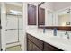 Bright bathroom featuring double sink vanity, storage, and glass-enclosed shower with natural light at 2416 Kings Gate Ln # 403, Mount Pleasant, SC 29466