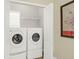 Convenient laundry room with stacked washer and dryer, wire shelving, and ample space for storage at 2416 Kings Gate Ln # 403, Mount Pleasant, SC 29466