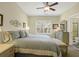 Serene primary bedroom with a king bed, soft lighting, and a window offering natural light and peaceful ambiance at 2416 Kings Gate Ln # 403, Mount Pleasant, SC 29466