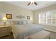 Relaxing bedroom with a king-size bed, neutral tones, and natural light from a window with plantation shutters at 2416 Kings Gate Ln # 403, Mount Pleasant, SC 29466