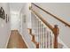Inviting staircase featuring carpeted steps, wooden handrail, and access to the upper level of the home at 2416 Kings Gate Ln # 403, Mount Pleasant, SC 29466