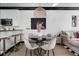 Stylish dining area features seating for four, with decorative lighting, and views into the living room at 263 St Philip St, Charleston, SC 29403