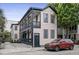 Charming two-story home featuring double balconies with black trim and a well-maintained yard and a brick driveway at 263 St Philip St, Charleston, SC 29403