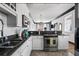 Well-lit kitchen boasts stainless steel appliances, sleek countertops, white cabinetry and modern fixtures at 263 St Philip St, Charleston, SC 29403
