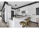 Bright kitchen with white cabinets, granite countertops, and stylish golden bar stools at 263 St Philip St, Charleston, SC 29403