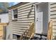 Back entrance of home with white door, wooden stairs, and beige siding at 2714 W Surrey Dr, North Charleston, SC 29405
