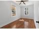 Empty bedroom with hardwood floors, two large windows, and neutral wall paint at 2714 W Surrey Dr, North Charleston, SC 29405