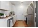 Modern, all-white kitchen with stainless steel appliances and wooden floors at 2714 W Surrey Dr, North Charleston, SC 29405