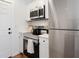Bright kitchen features stainless steel appliances, white cabinets, and an exterior door at 2714 W Surrey Dr, North Charleston, SC 29405
