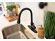 Close-up on kitchen sink and faucet with decor on a white countertop and backsplash at 2714 W Surrey Dr, North Charleston, SC 29405