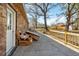 View of the backyard patio and a wooden bench underneath mature trees at 28 Elmora Ave, Goose Creek, SC 29445