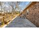 View of backyard patio area with wooden bench near brick house at 28 Elmora Ave, Goose Creek, SC 29445