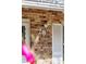 Close-up of brick facade with house number, security light, and window with white shutters at 28 Elmora Ave, Goose Creek, SC 29445