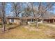 Quaint brick home with blossoming shrubs and a well-manicured lawn, offering curb appeal at 28 Elmora Ave, Goose Creek, SC 29445