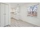A vintage kitchenette design with white walls, cabinetry, and gray wood-look flooring at 28 Elmora Ave, Goose Creek, SC 29445