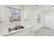 View of the kitchen counter and sink underneath a window, with gray wood-look flooring at 28 Elmora Ave, Goose Creek, SC 29445