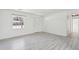 Bright living room featuring wood-look flooring, a window, and a white front door at 28 Elmora Ave, Goose Creek, SC 29445