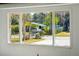 Bright window view of a yellow home and surrounding trees at 28 Elmora Ave, Goose Creek, SC 29445