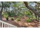 View of the backyard with beautiful trees and low-maintenance landscaping at 2837 Baywood Dr, Seabrook Island, SC 29455