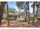 Charming home exterior showcasing a wooden deck with rocking chairs, surrounded by trees at 2837 Baywood Dr, Seabrook Island, SC 29455