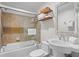 Bright bathroom features a shower-tub combo with tile surround and a pedestal sink at 2837 Baywood Dr, Seabrook Island, SC 29455