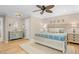 Primary bedroom featuring a white bed, hardwood floors, soft colors, and a bathroom vanity area at 2837 Baywood Dr, Seabrook Island, SC 29455