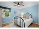 Bright bedroom with hardwood floors, soft colors, and a window with a view of the trees at 2837 Baywood Dr, Seabrook Island, SC 29455