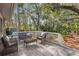 Relaxing deck surrounded by lush trees with comfortable seating, great for outdoor living at 2837 Baywood Dr, Seabrook Island, SC 29455