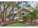 Charming single-story home featuring a well-manicured lawn, lush trees, and inviting front porch at 2837 Baywood Dr, Seabrook Island, SC 29455