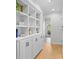 Bright hallway with hardwood floors, custom built-ins, and views of lush landscaping at 2837 Baywood Dr, Seabrook Island, SC 29455