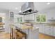 Bright kitchen with white cabinets, granite countertops, and a cozy breakfast bar at 2837 Baywood Dr, Seabrook Island, SC 29455