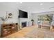 Cozy living room with a fireplace, TV, comfortable seating, and sliding glass doors at 2837 Baywood Dr, Seabrook Island, SC 29455