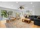 Spacious living room features hardwood floors, a fireplace, and sliding glass doors to the outside at 2837 Baywood Dr, Seabrook Island, SC 29455