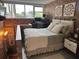 A bedroom with exposed brick, a large window, decor, and furniture at 309 Meeting St # 19, Charleston, SC 29401