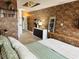 Stunning primary bedroom with brick accent wall, unique decor, and comfortable bed at 309 Meeting St # 19, Charleston, SC 29401