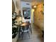 Dining area with table set for four, decorative plates on the wall, and view of the hallway at 309 Meeting St # 19, Charleston, SC 29401
