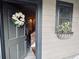 Entrance features gray door with flower wreath, window box with flowers, and a glimpse of the interior at 309 Meeting St # 19, Charleston, SC 29401