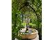 The brick-lined garden features a water fountain and manicured landscaping, viewed through an overhead arbor at 309 Meeting St # 19, Charleston, SC 29401