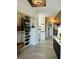 Bright hallway with built-in closet, decorative wallpaper, unique brick accents, and access to a powder room at 309 Meeting St # 19, Charleston, SC 29401